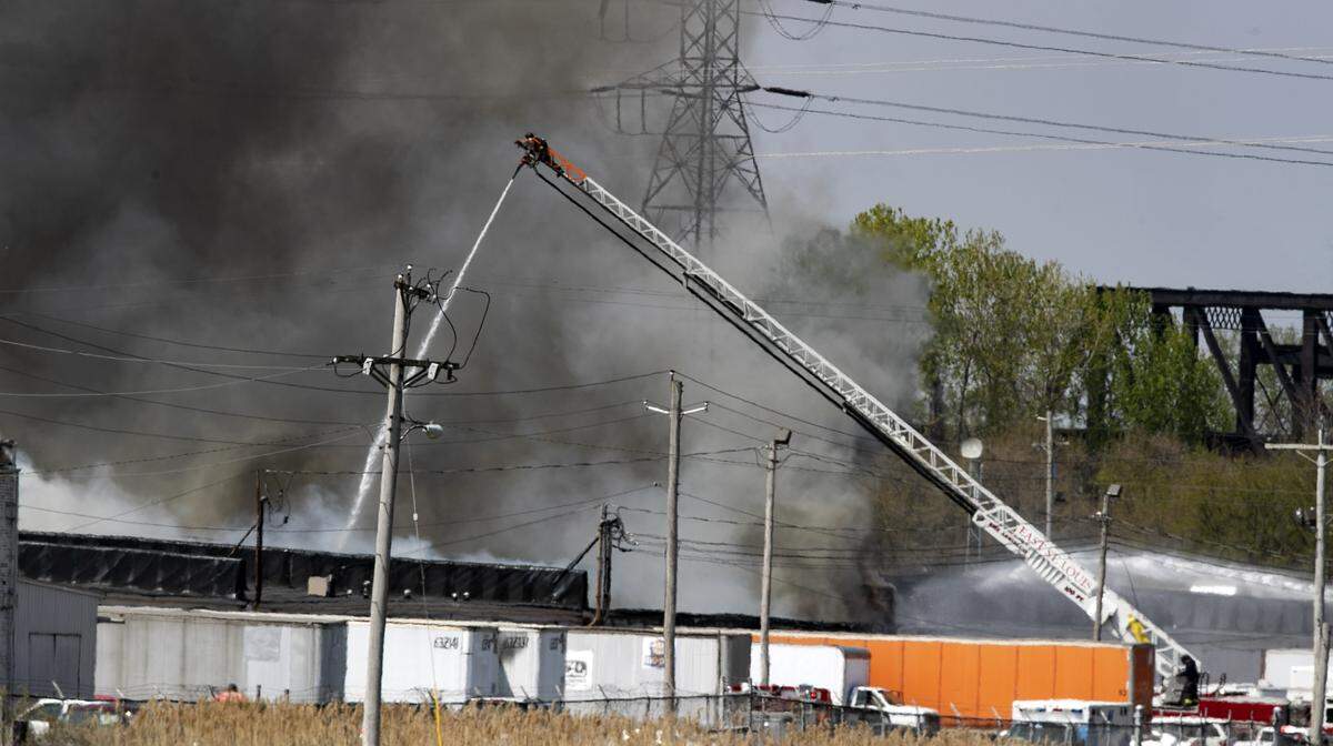 Firefighters from several agencies work to extinguish a fire at a warehouse just north of Pop’s in Sauget, Illinois.