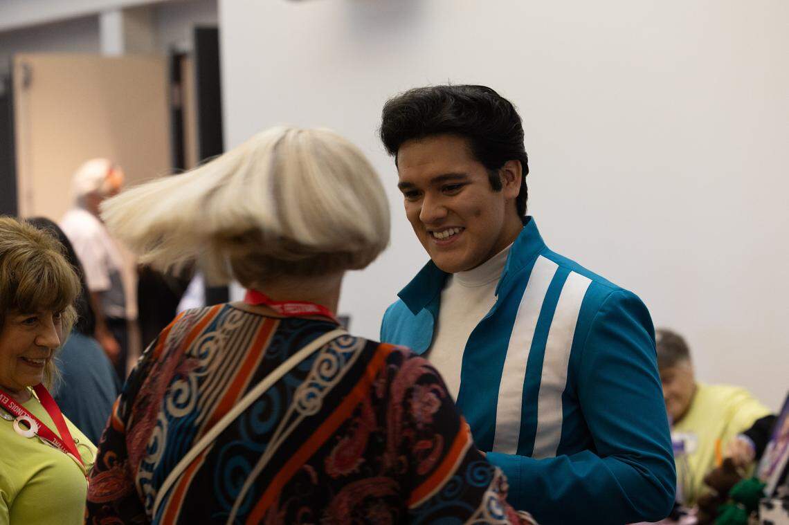 Chicago Elvis tribute performer Hugo Colin stands amongst fans in the convention center prior to going on. Colin makes his own clothes and even majored in fashion design.