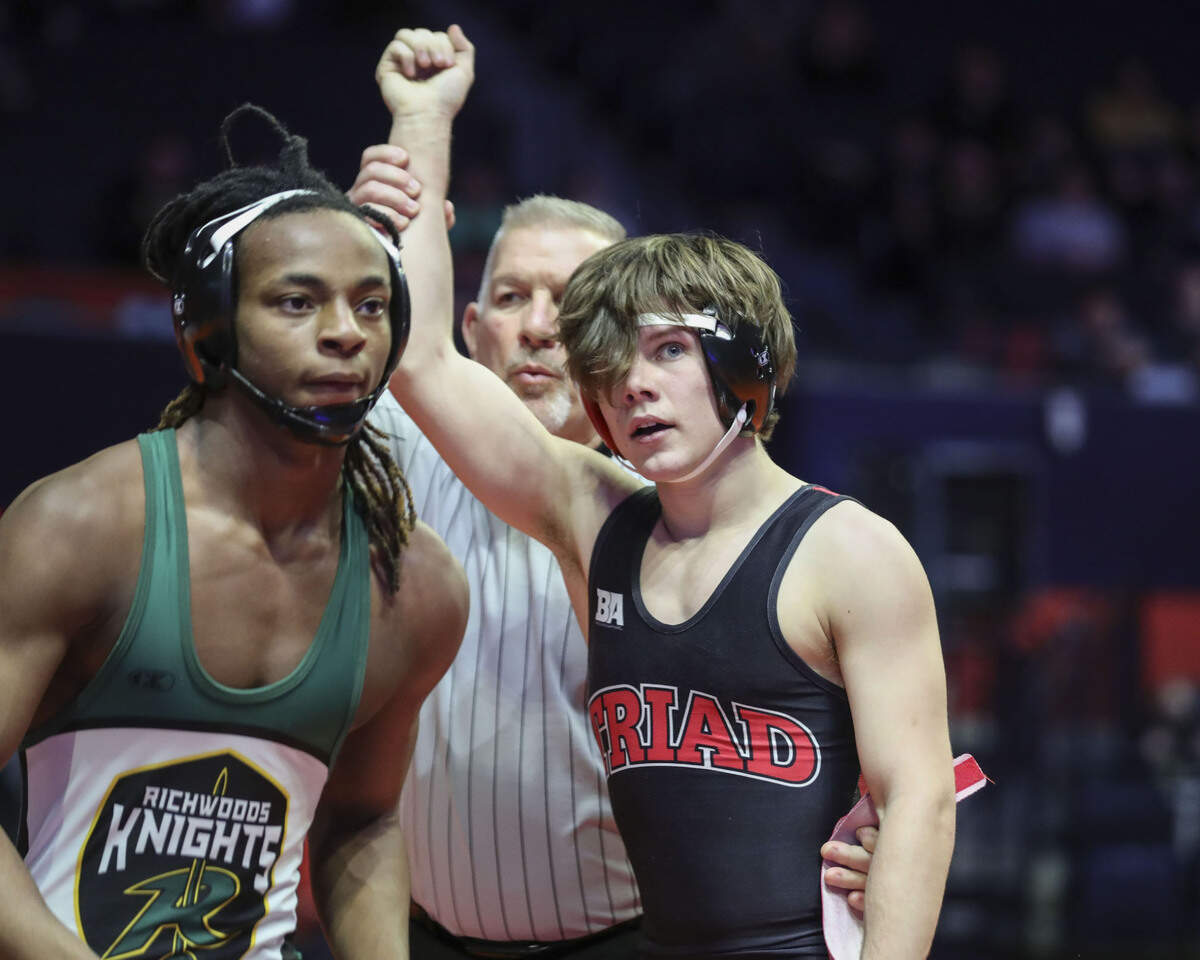 Triad’s Colby Crouch has his hand raised after defeating Richwoods’s Bernard Cox by fall at 1:36 in their preliminary match. Crouch went on to win his quarterfinal match by fall at :46 during the 2023 IHSA Individual Wrestling State Finals on Thursday in Champaign.
