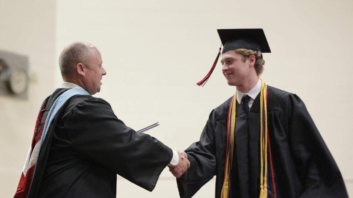 Highland School District Superintendent Mike Sutton had Cameron Altadonna his diploma during HHS graduation on May 20. On May 21, Sutton signed a new four-year employment contract with the district.
