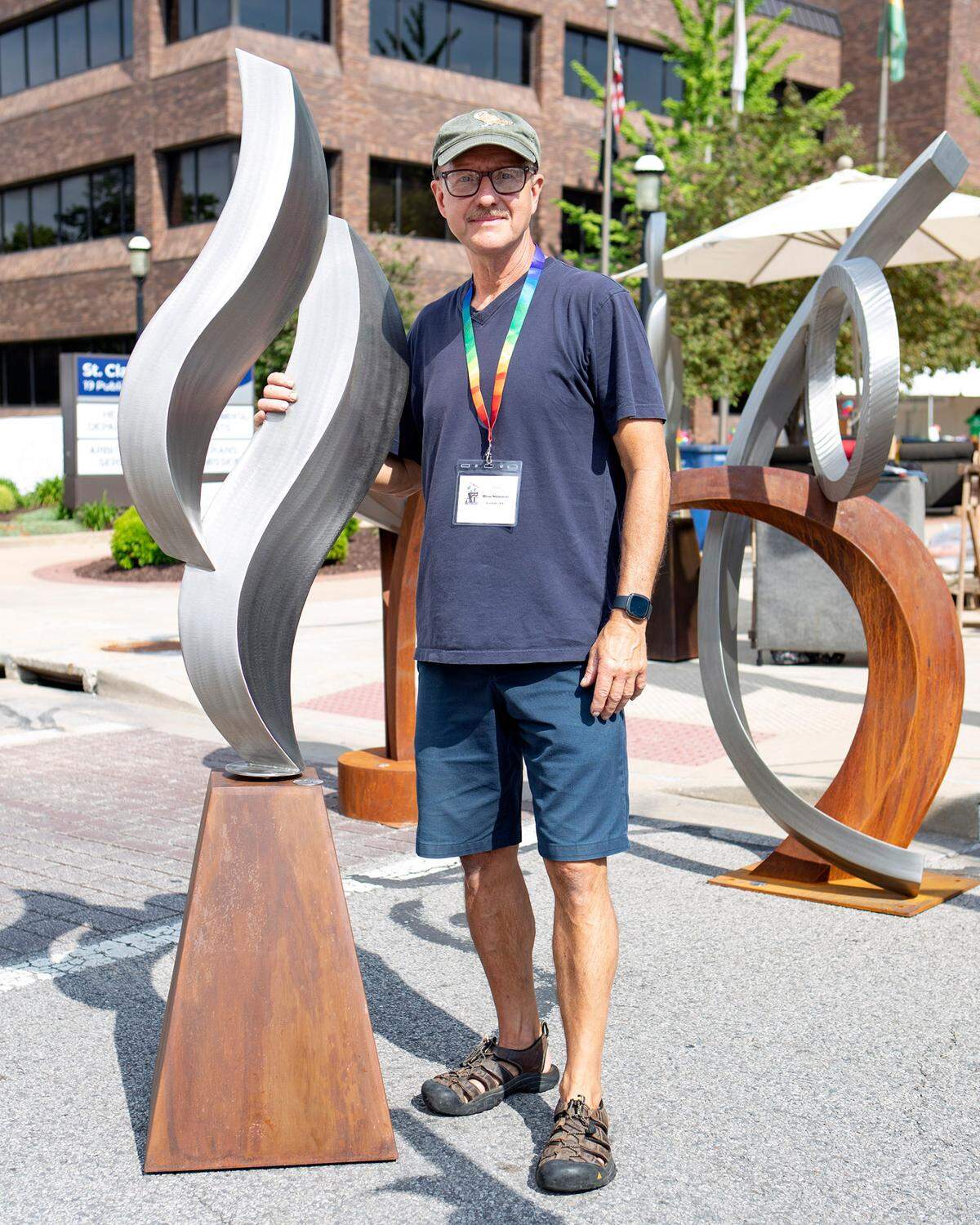 Artist Ron Stinson of Carlisle, PA stands next to one of his fine art pieces Saturday, May 14, 2022, during Art on the Square in Belleville. The event continues Sunday.