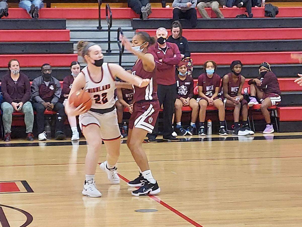 Highland’s Emma Warner looks to clear space around Belleville West’s Lamiya Terrell during a non-conference game at Highland High School. Belleville West defeated the Lady Bulldogs 61-28.