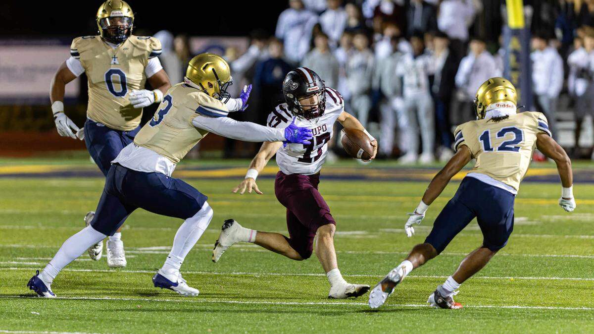 November 1, 2024 - Belleville IL, Dupo Alec Underwood (17) carries the ball while under pressure during FridayÕs IHSA first round playoff games between Althoff Crusaders and Dupo Tigers [Photo: Jimmy Simmons]