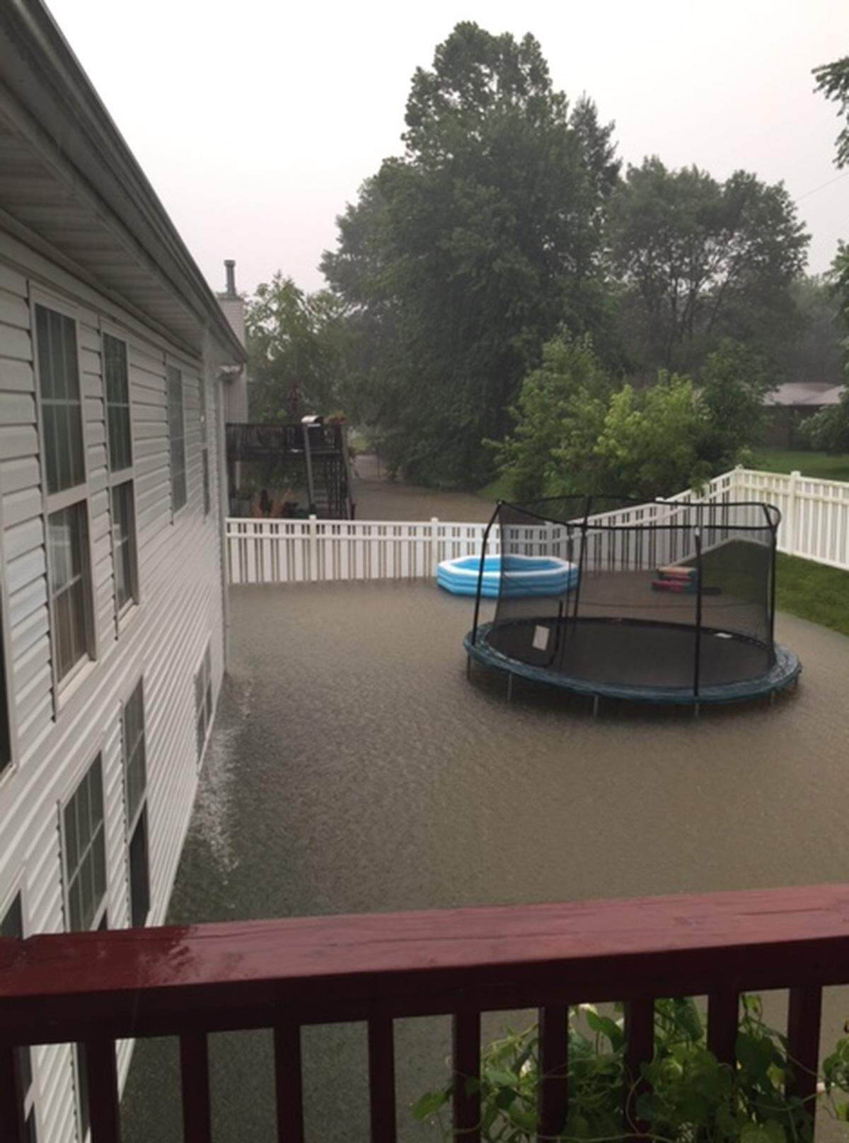 Storm water backs up in a backyard on Burlington Drive in Troy after a July 2016 storm.