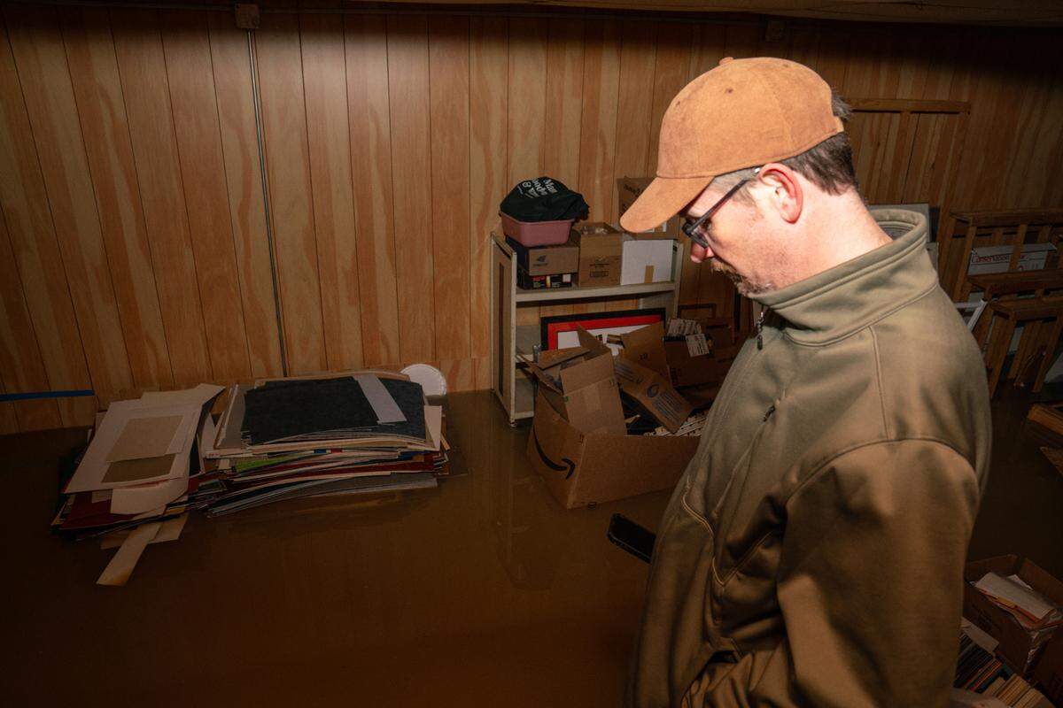 Tom Wodarczyk stares at the water filling his basement on Belleville’s Main St. Flooding on Main St. on Dec. 4 as a result from a ruptured water main stretched from the corner of Main and Church St. to High St. Many businesses on the north side of the street experienced flooding in their basements.