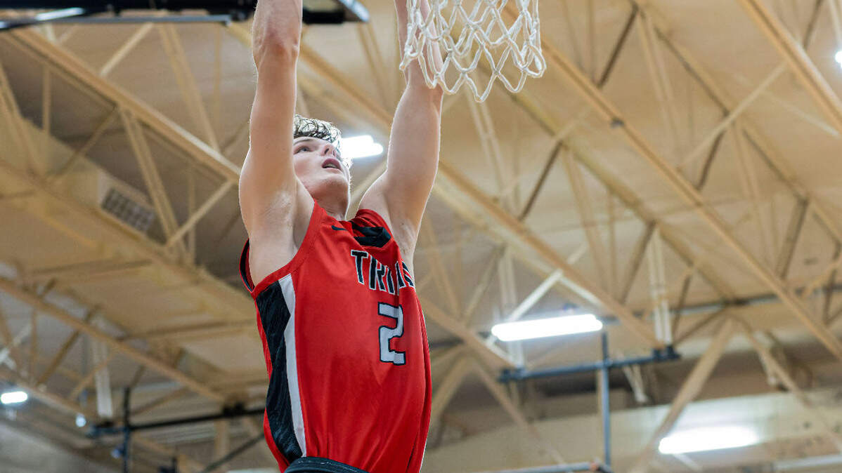 Triad’s Jake Stewart goes up for the dunk during Friday night’s Mississippi Valley Conference game against Highland. The Knights ultimately posted a 50-37 victory.