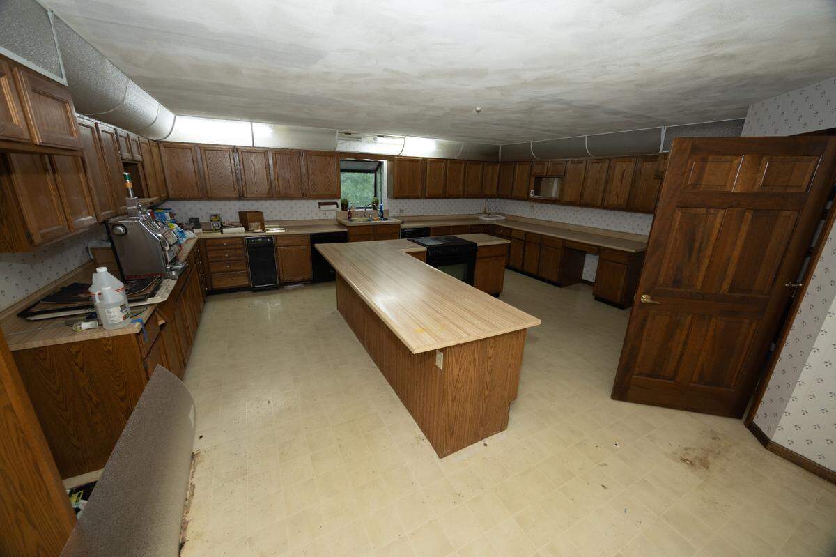 The home also features a massive wrap-around kitchen that, although in need of repairs, would provide an excellent project for anyone looking to build their dream kitchen.