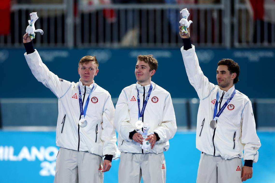 MILAN, ITALY - FEBRUARY 17: Silver medalist Ethan Cepuran, Casey Dawson and Emery Lehman of Team United States celebrate on the podium during the medal ceremony for the Speed Skating Men's Team Pursuit on day eleven of the Milano Cortina 2026 Winter Olympic games at Milano Speed Skating Stadium on February 17, 2026 in Milan, Italy. (Photo by Elsa Garrison/Getty Images)