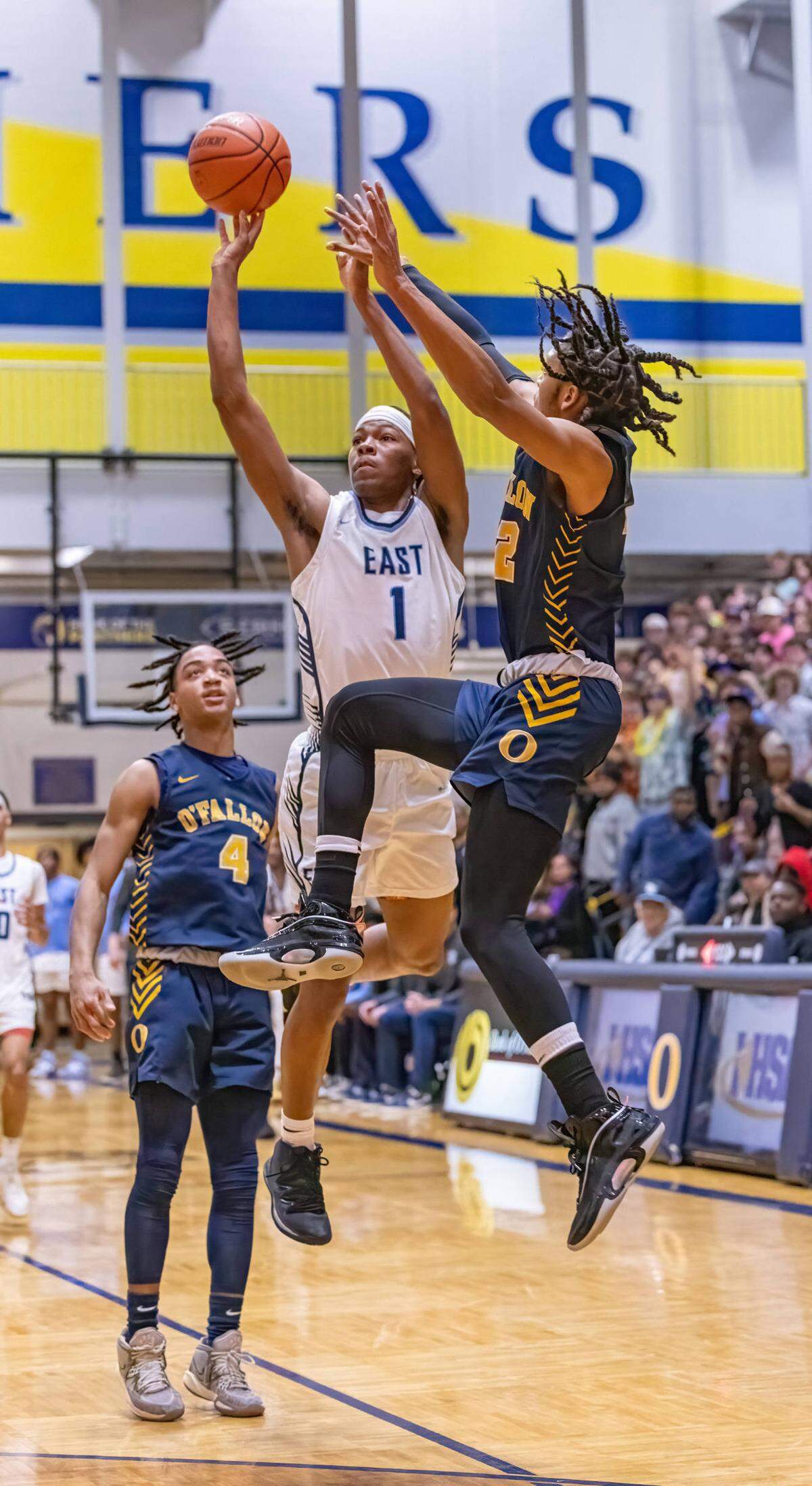 Belleville East’s Jordan Pickett makes a 3-pointer with 0.4 seconds left in the second quarter during Friday night’s IHSA Class 4A regional championship game. The Lancers ultimately fell to the Panthers 52-50.
