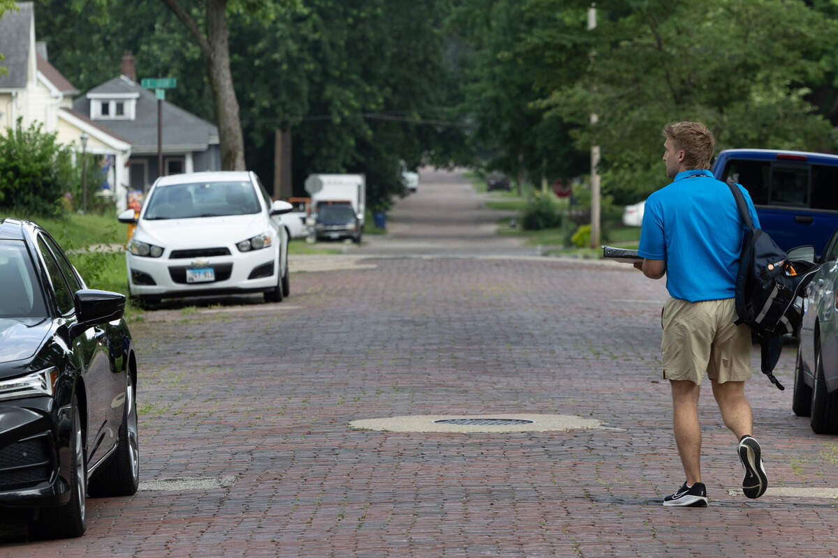 Maksim Djurjagin makes his way down Portland Avenue in Belleville on Monday. He’s a licensed solicitor for Southwestern Advantage, of Nashville, Tennessee, which publishes educational materials.