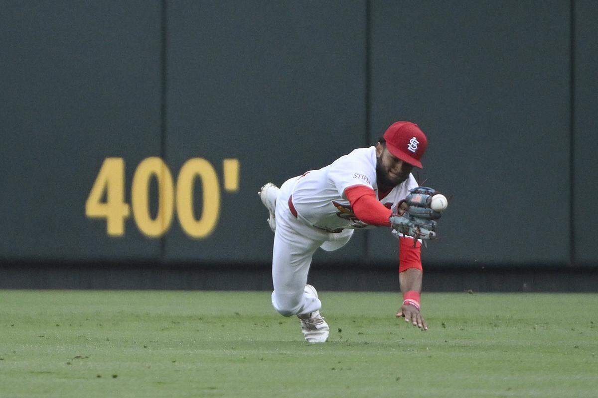 Victor Scott II (11) dives but is unable to catch a line drive hit by Philadelphia Phillies catcher J.T. Realmuto (not pictured) during the seventh inning at Busch Stadium. Mandatory Credit: Jeff Curry-USA TODAY Sports