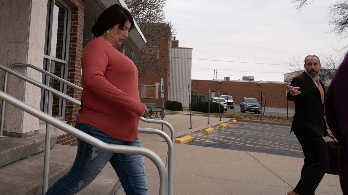 Heather Sullivan leaves the Madison County Criminal Justice Center in Edwardsville on Friday after pleading guilty to stealing $64,000 from Esprit Metro Fastpitch Softball. At right is her attorney, Jeremy Sackett.