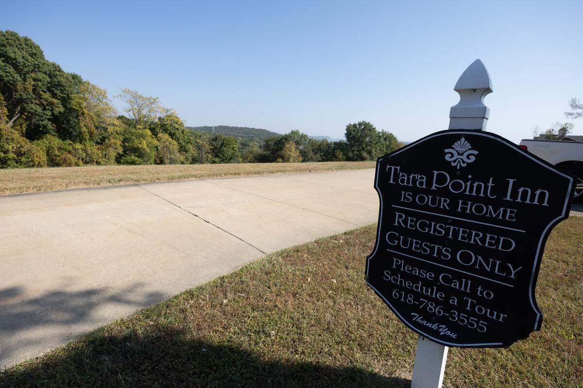 The Tara Point Inn is located on an isolated hill, where visitors are welcomed by charming yard decor and quaint signs.