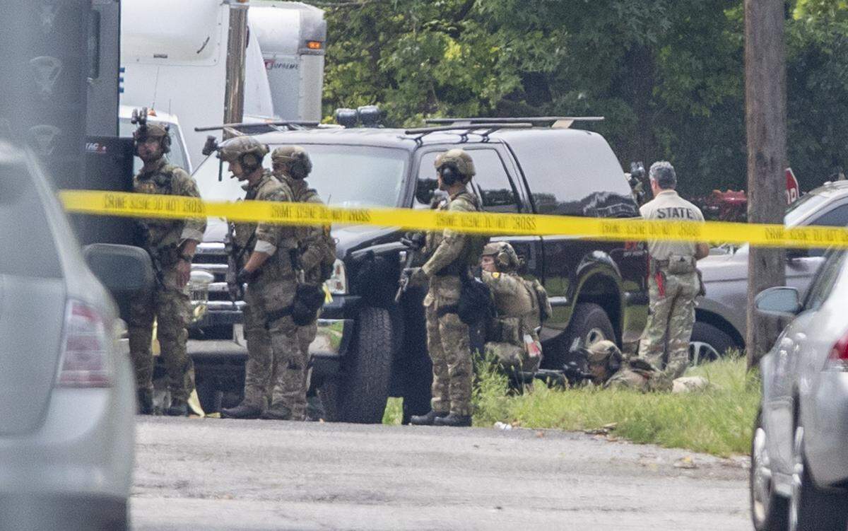 Several agencies work with Illinois State Police in East St. Louis Friday after and Illinois State Police trooper was shot.