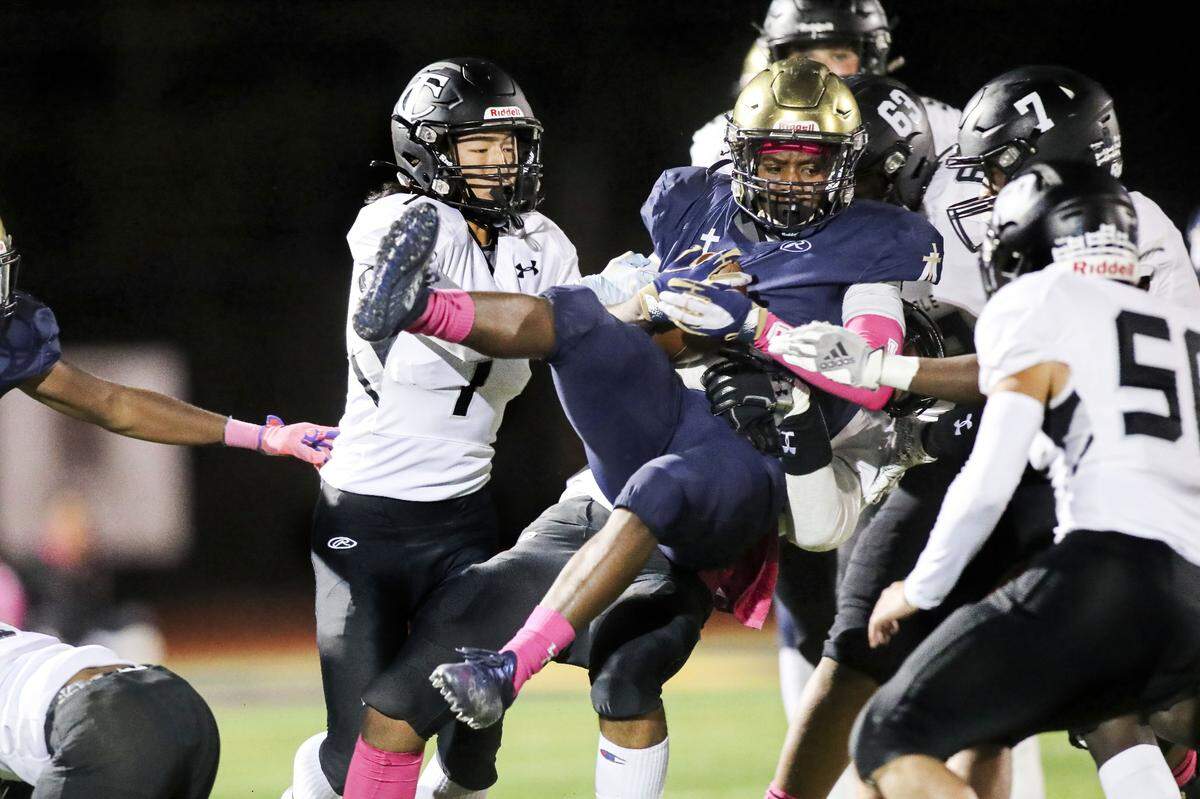 Althoff’s Lucious Dones is upended by a group of Carbondale defenders during a South Seven Conference matchup against Carbondale earlier this month. The Crusaders opened the IHSA Class 2A postseason Friday night against Shelbyville.