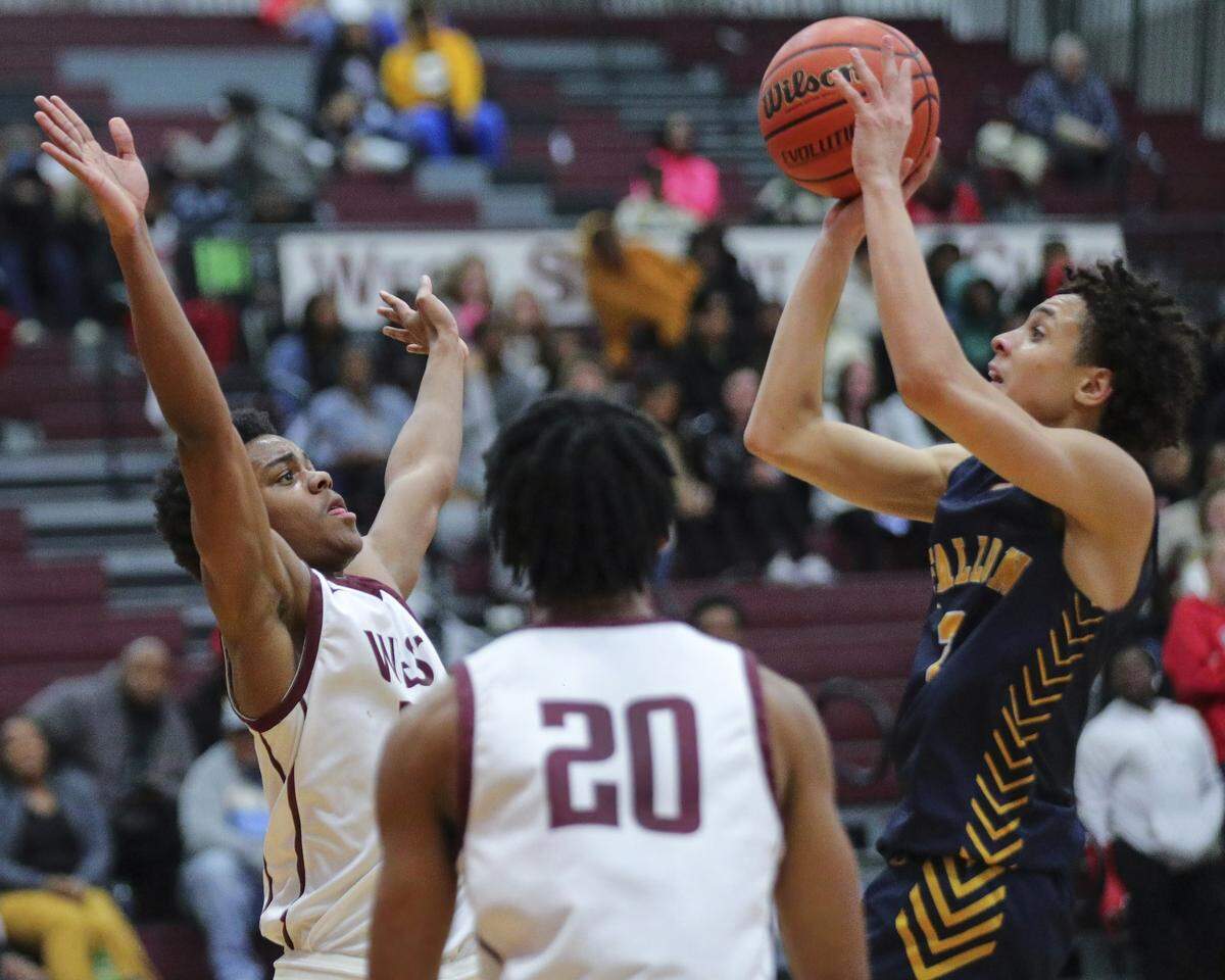 O’Fallon’s Jaeden Rush takes a shot over Belleville West’s Quincy Cotton during a Southwestern Conference game against Belleville West earlier this month. The Panthers were back in action Friday night against Edwardsville.