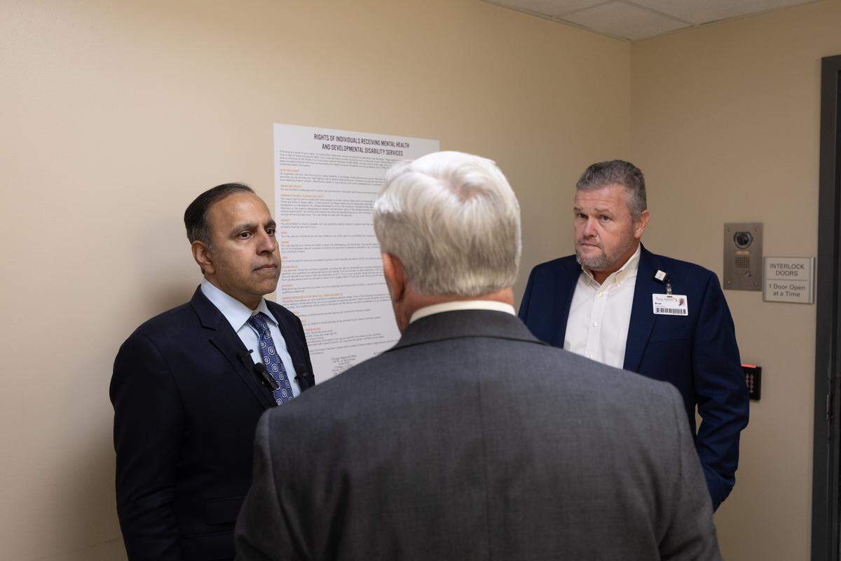 U.S. Rep. Raja Krishnamoorthi speaks with Touchette Regional Hospital CEO Larry McCulley (center) and President Brad Goecher (right) during a visit to the metro-east hospital.