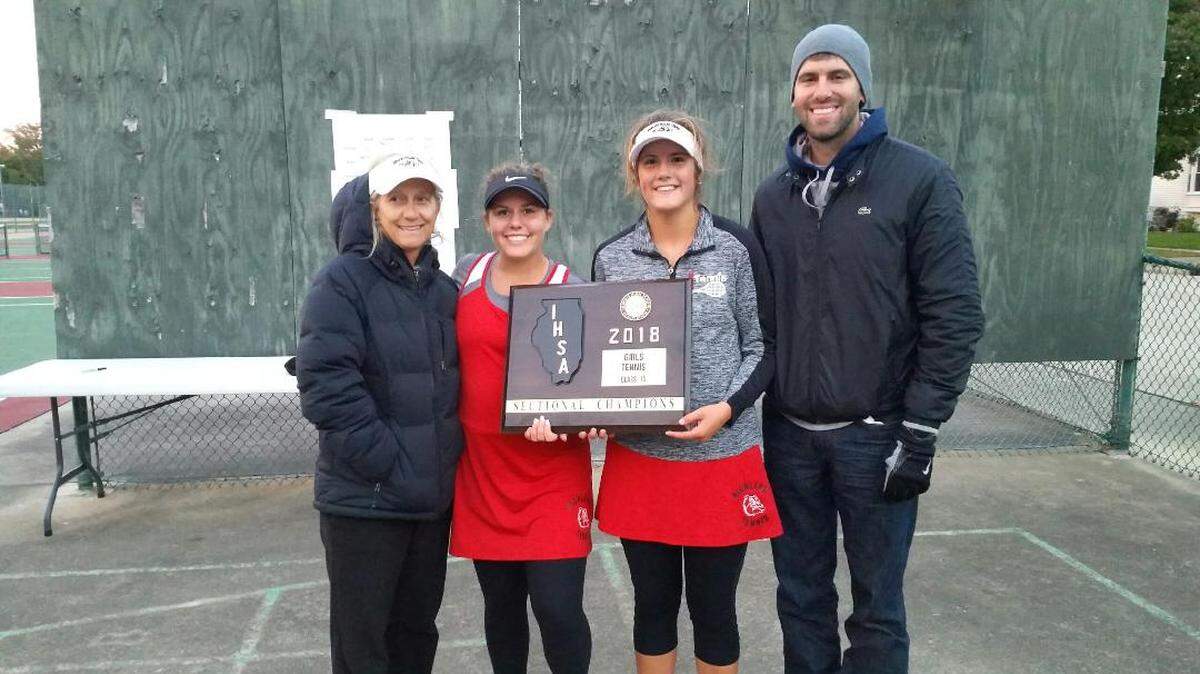 Kate Feldmann (left) and Taylor Fleming (right) grip the Class 1A sectional trophy after Highland won the tournament Monday in Centralia. On the left of Feldmann is assistant coach Brenda Plocher and on the right of Fleming is Highland head coach Matt Pellock.
