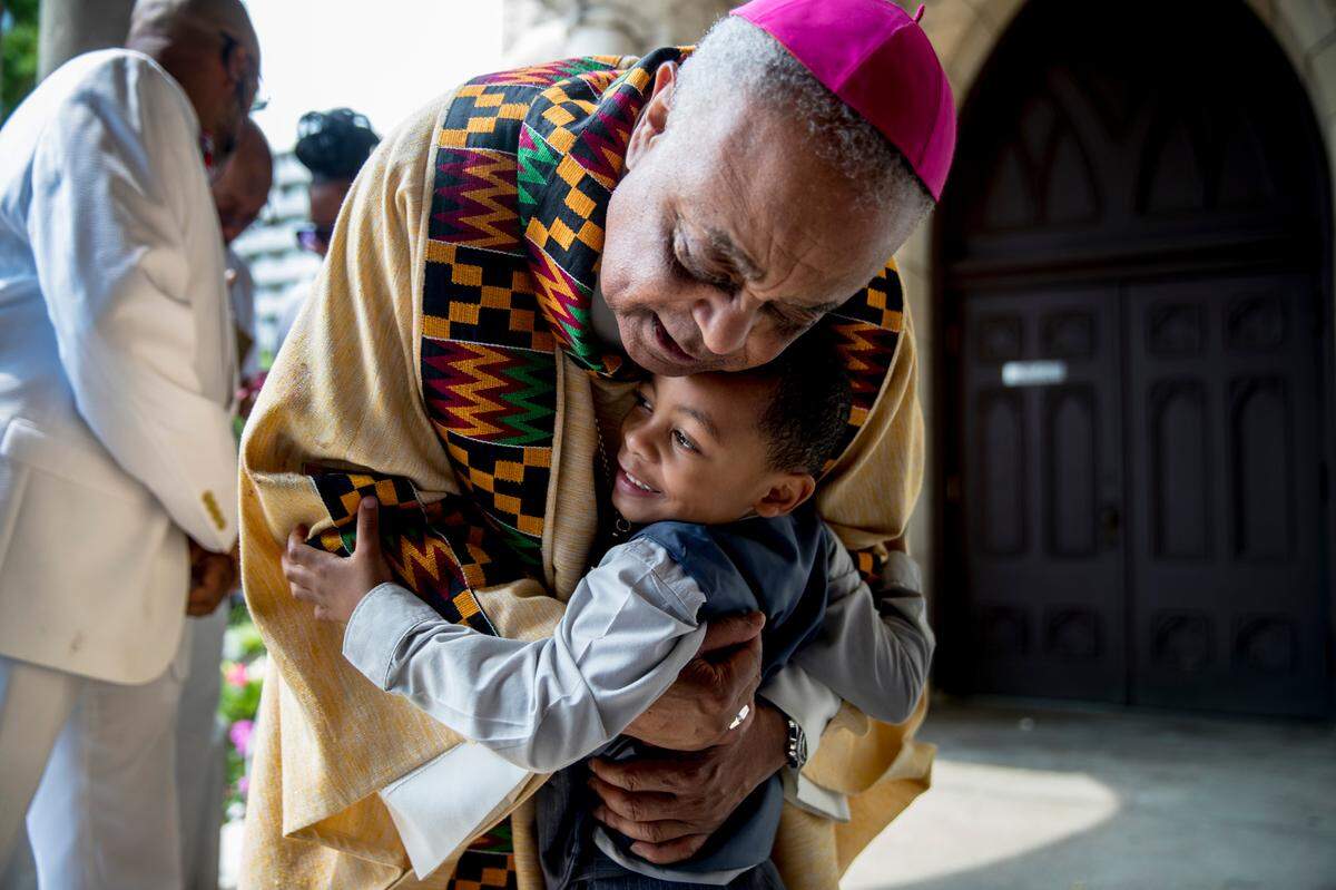 The Most Rev. Wilton D. Gregory hugs Noah Tanner, 4, after a Mass at St. Augustine Catholic Church on June 2, 2019, less than two weeks after he was installed as archbishop of Washington.