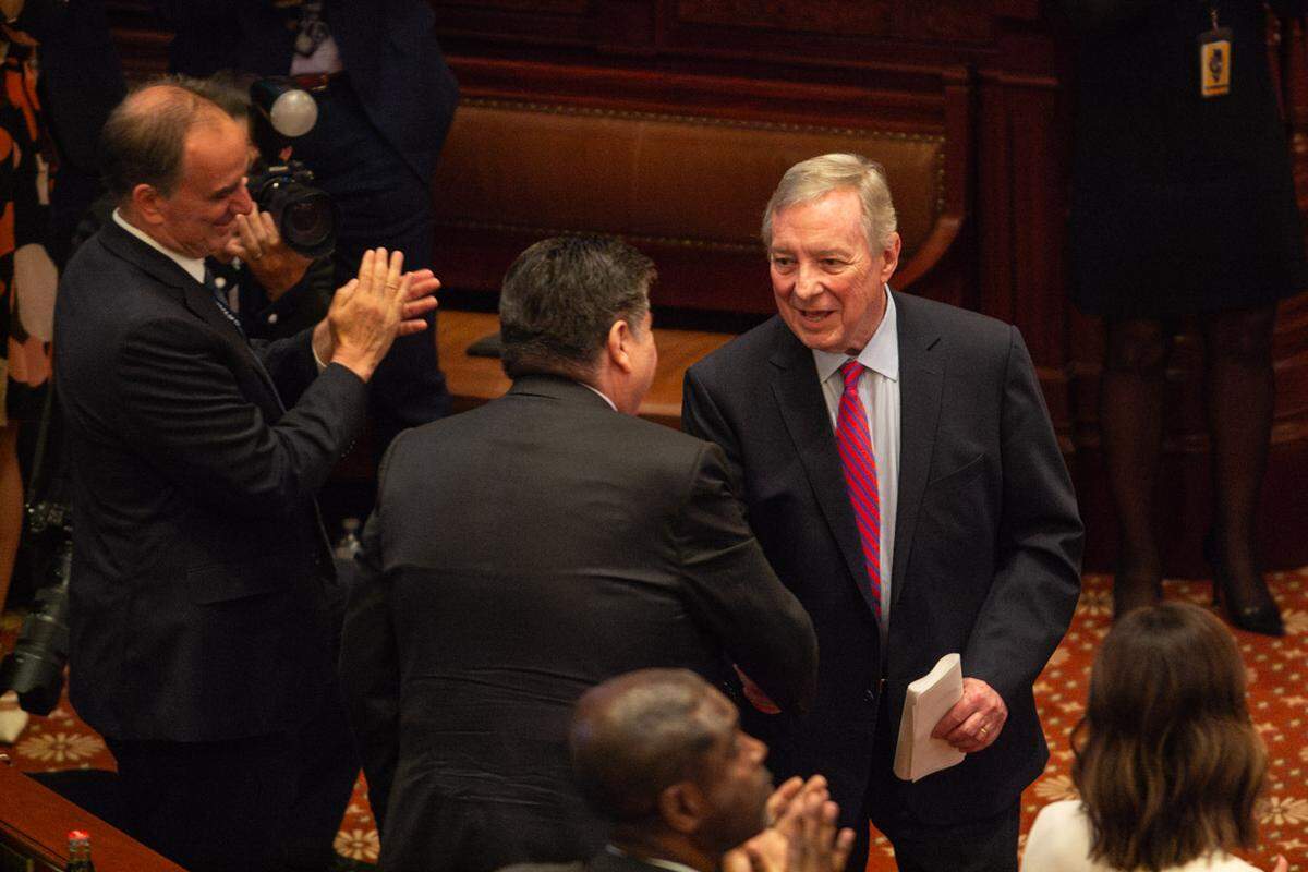 Sen. Dick Durbin and Gov. JB Pritzker shake hands after Durbin’s farewell address to Illinois lawmakers on May 27, 2026.