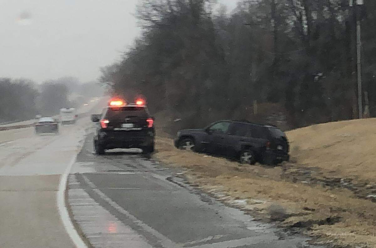 A Belleville police officer stops to assist a driver who had slid off westbound Illinois 15 near Frank Scott Parkway at about 2 p.m. Thursday.