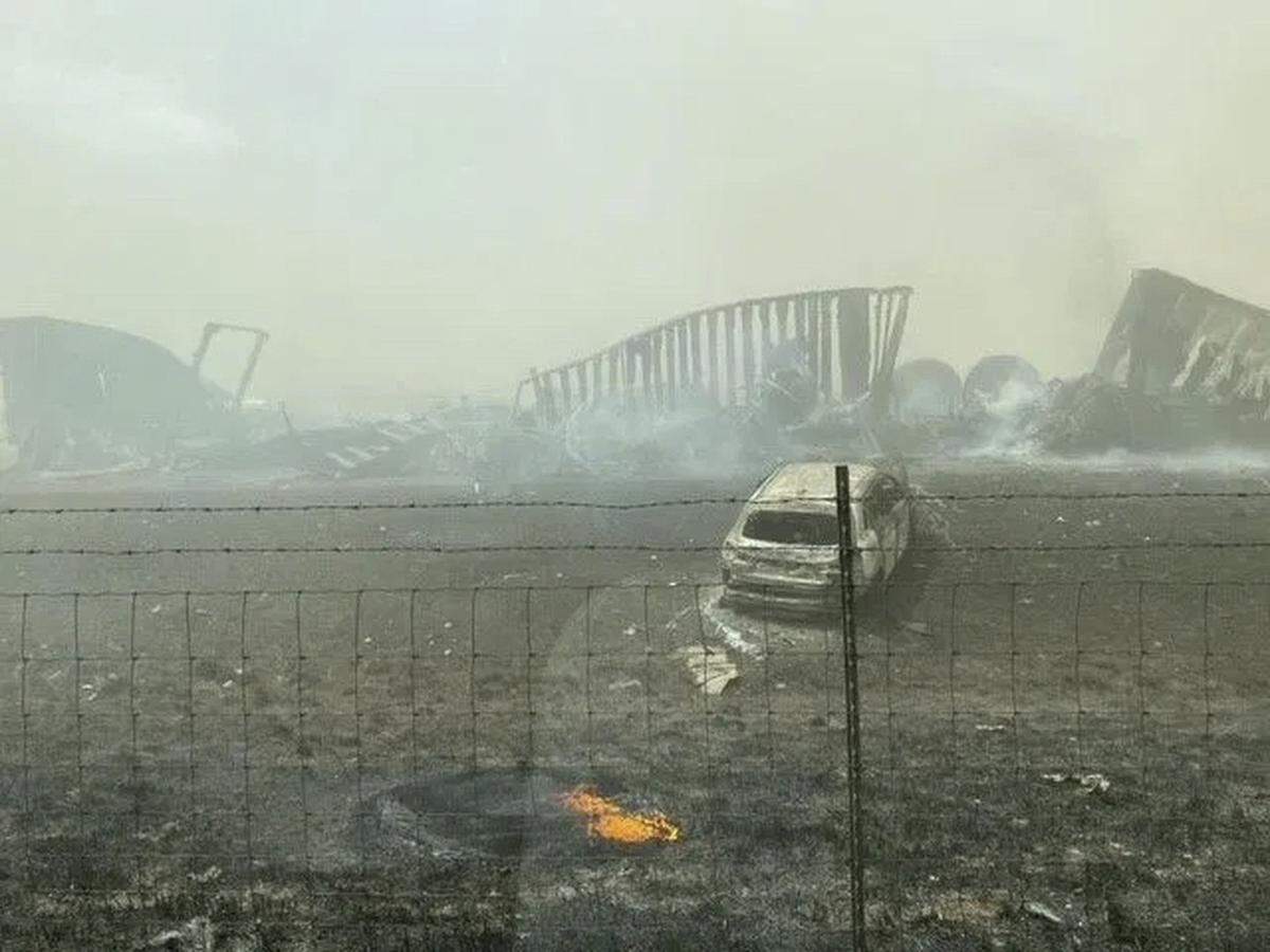 Smoldering wreckage is seen after a crash involving at least 72 vehicles shut down a highway in Illinois, Monday, May 1, 2023. Illinois State Police say a windstorm that kicked up clouds of dust in south-central Illinois led to numerous crashes and seven fatalities on Interstate 55. (WICS TV via AP)