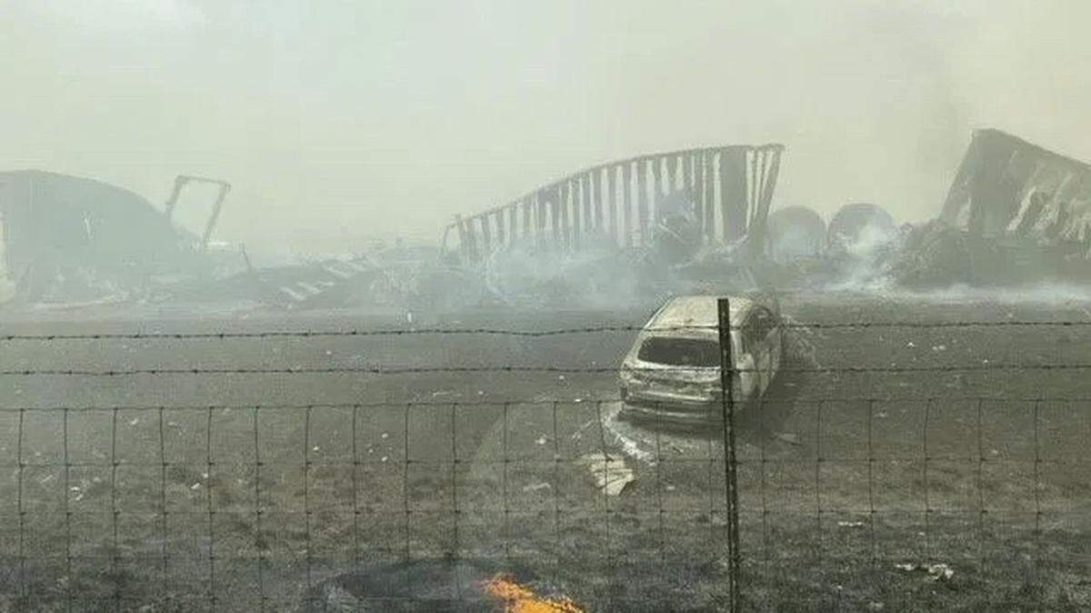 Smoldering wreckage is seen after a crash involving at least 20 vehicles shut down a highway in Illinois, Monday, May 1, 2023. Illinois State Police say a windstorm that kicked up clouds of dust in south-central Illinois led to numerous crashes and multiple fatalities on Interstate 55. (WICS TV via AP)
