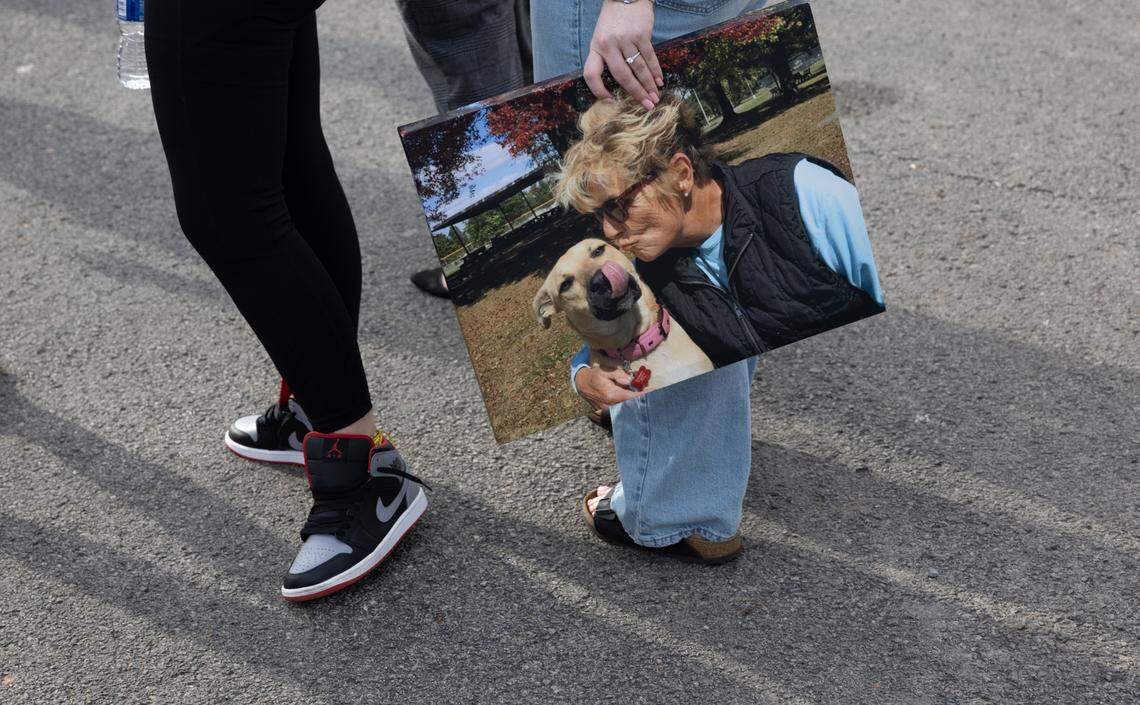 A supporter holds a photo of Susanne Tomlinson on Monday outside the Madison County Criminal Justice Center in Edwardsville. She had just attended a hearing for a man who was sentenced for killing Susanne Tomlinson by setting her Troy duplex on fire.