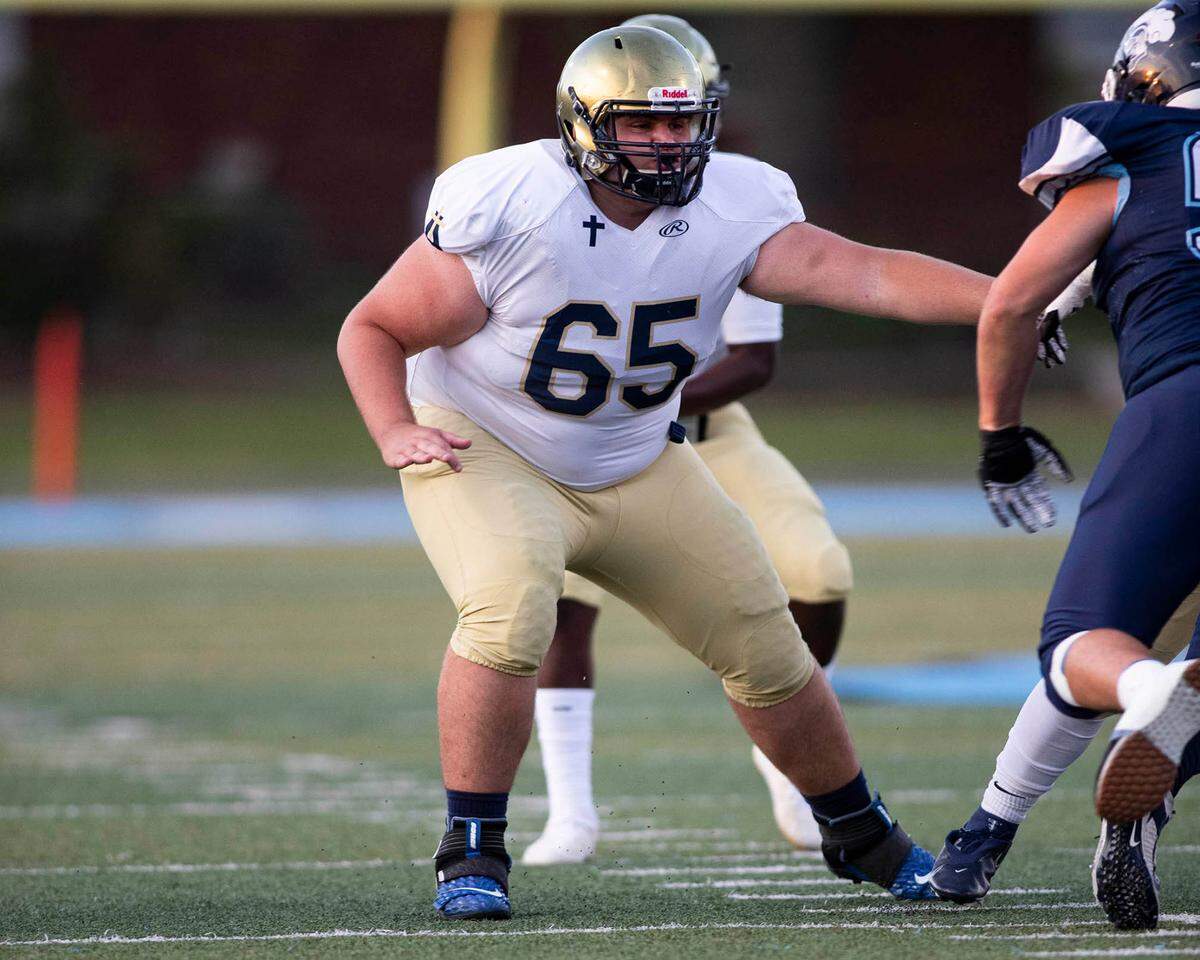 Althoff’s Auggie Prange offers pass protection for quarterback Braylon Grayson against Mater Dei on Friday night. The Crusaders went on to a 13-7 win.