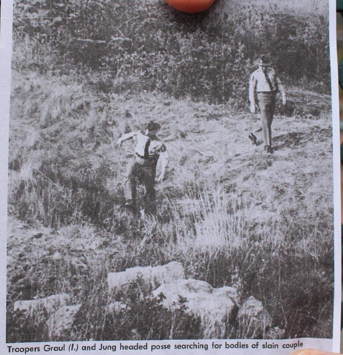 This newspaper photo shows Illinois State Police troopers Charles Graul, left, and Dave Jung searching for the bodies of Mike Morrison and Debbie Means in 1969.