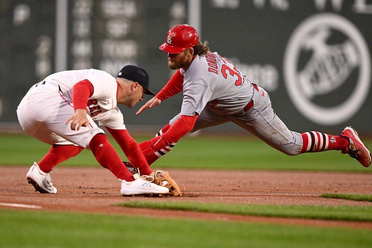 BOSTON, MASSACHUSETTS - APRIL 06: Alex Bregman #2 of the Boston Red Sox gloves the ball before tagging out Brendan Donovan #33 of the St. Louis Cardinals attempting to steal third base during the first inning at Fenway Park on April 06, 2025 in Boston, Massachusetts. (Photo by Brian Fluharty/Getty Images)
