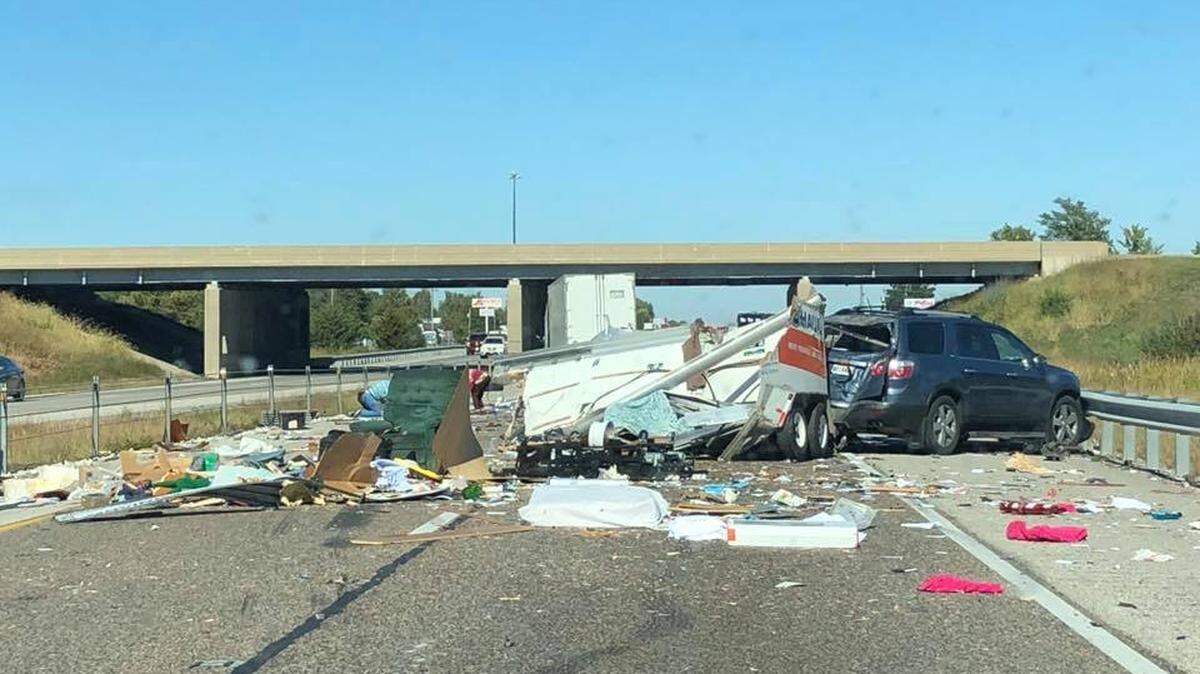Traffic was backed up on Interstate 55 at Illinois 143 after a tractor-trailer hit a U-Haul trailer, sending debris across all lanes of the highway.