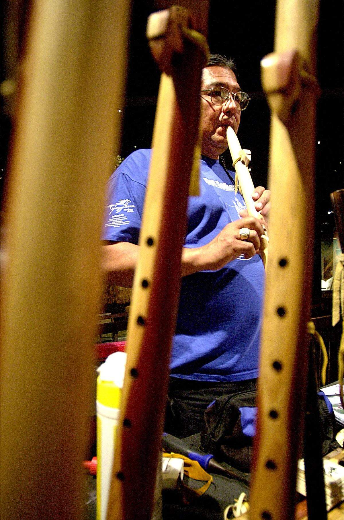 William Harjo plays one of his hand-crafted cedar woodwinds while at the Contemporary Indian Art Show at Cahokia Mounds State Historic Site, Collinsville.