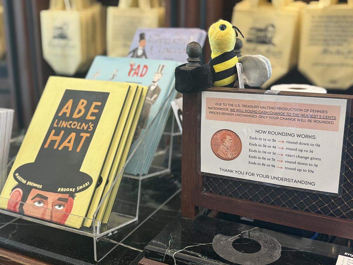 The gift shop at the Abraham Lincoln Presidential Museum has a printed guide for customers explaining how its penny rounding system works.