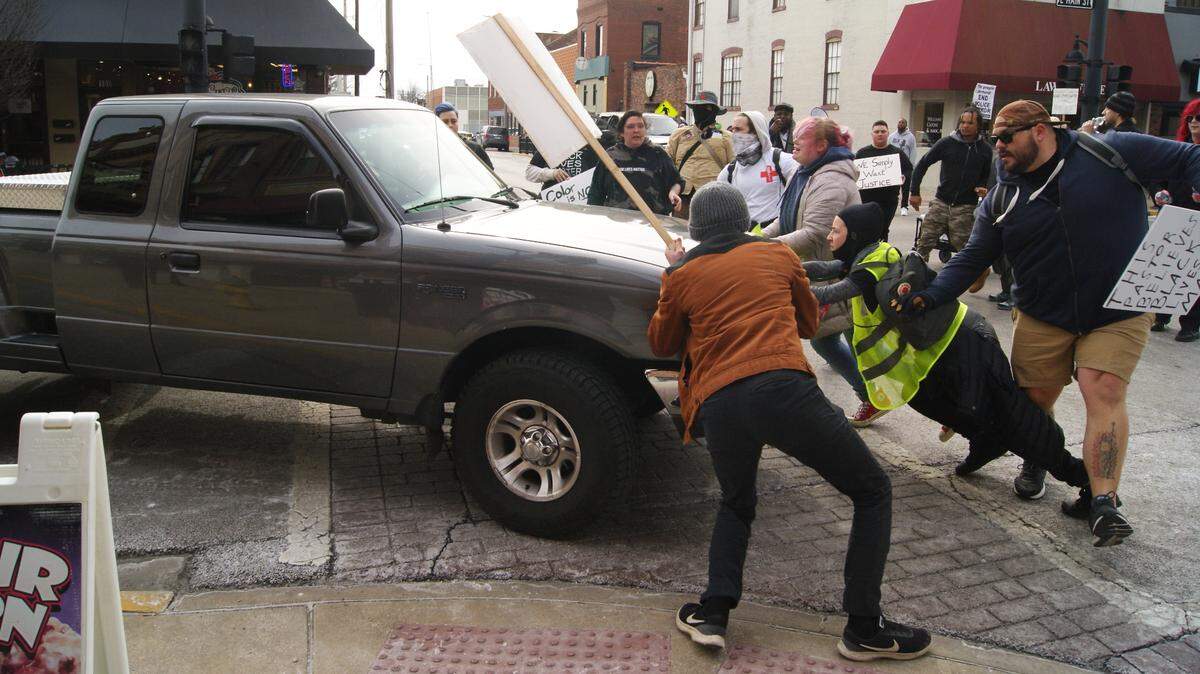 The driver of a pickup truck drove into a group of protesters who then tried to stop the truck at about 1 p.m. Feb. 4 at the corner of East Main and North High streets in downtown Belleville. After the truck turned onto North High Street, protesters ran after the truck and an escort vehicle followed the truck.