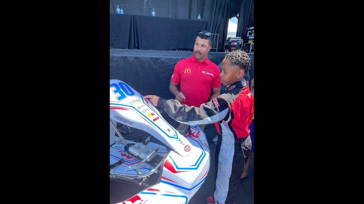 NASCAR Cup Series driver Bubba Wallace, left, meets with Josiah Unaeze, 12, of Belleville at the World Wide Technology Raceway in Madison during a pre-race event for the Enjoy Illinois 300. Josiah is the winner of the inaugural Ignite Scholarship awarded by the Raceway Gives Foundation, the charitable arm of the track.