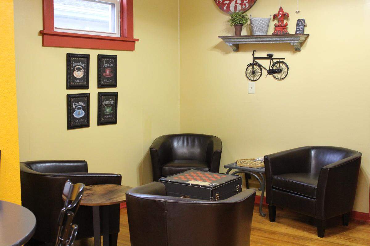 The Red Porch cafe in New Baden has a sitting area where people can drink coffee and socialize, play checkers or read books from its Free Little Library.