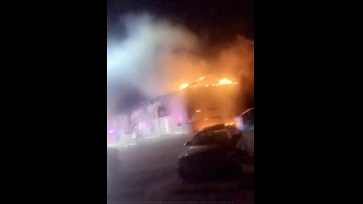 This image from a video shot Sunday evening shows flames coming out of an eight-unit building at Cottonwood Park Apartments in Cahokia Heights, the day after firefighters put out a fire.