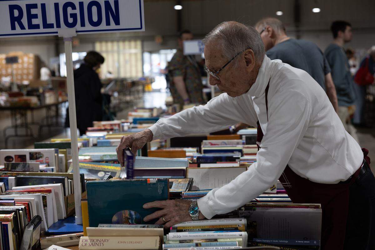 Richard Palmer, 90, and a member of the Belleville Memorial Hospital Auxiliary, helps to organize books during the 2026 Book Bazaar at the Belle-Clair Fairgrounds. “I’m very blessed to do what I do,” Palmer said Thursday.