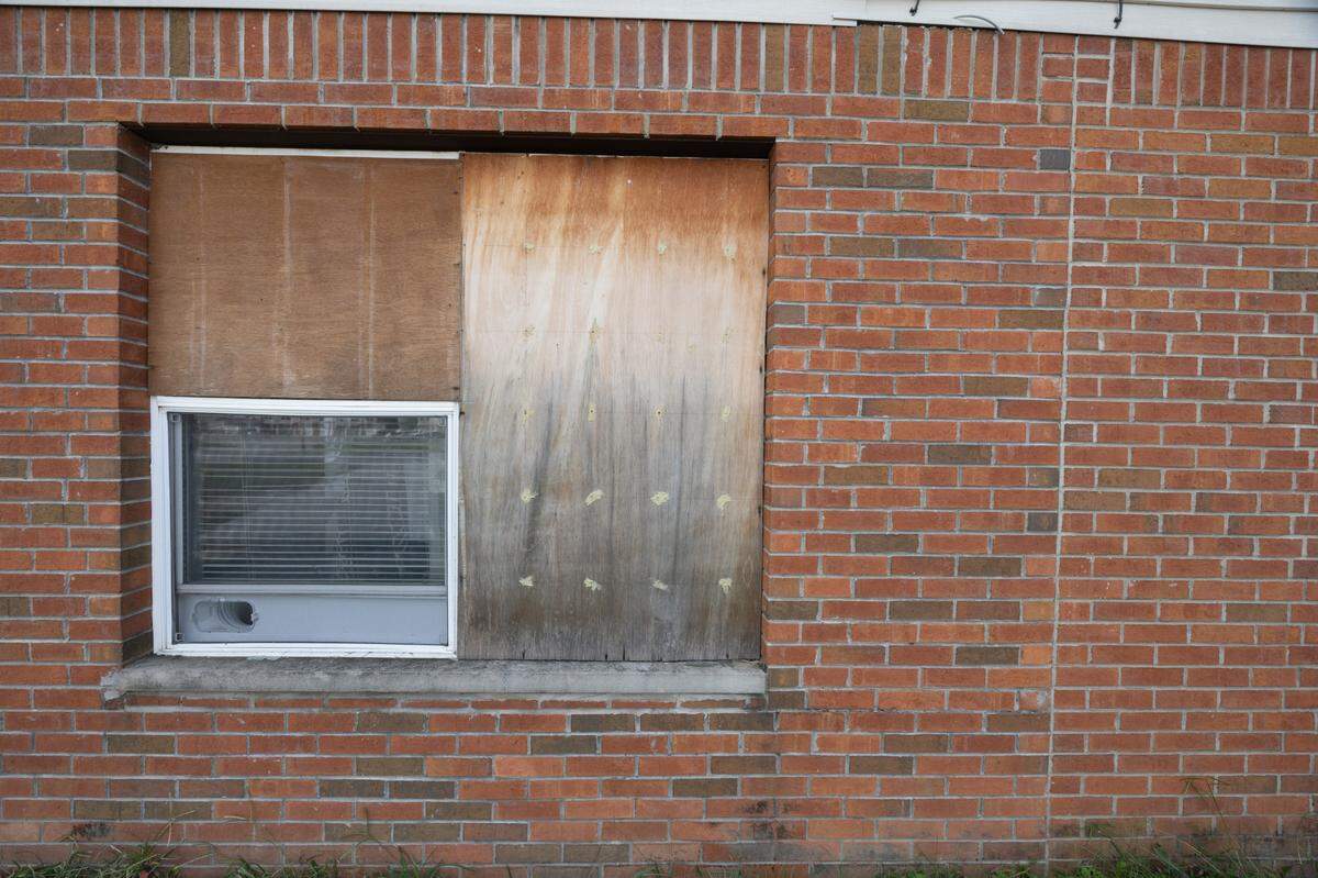 A window in Tracy Smith and Barry Bagley’s Centreville Courts apartment has been broken since January 2022. Management covered it with plywood.