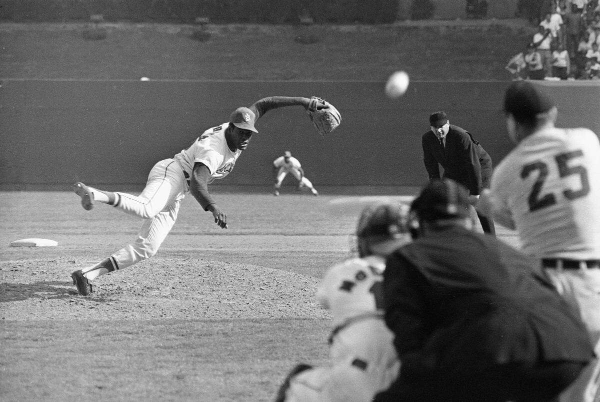 Bob Gibson, St. Louis Cardinals ace pitcher fires the ball at Detroit Tigers Norm Cash in the ninth inning of the first game of the World Series Oct. 2, 1968 at Busch stadium in St. Louis, Mo. Gibson struck Cash out for the 16th strikeout of the game and set a new World Series record. Looking on are catcher Tim McCarver, home plate umpire Tom Gorman and first base umpire Jim Honochick. (AP Photo)