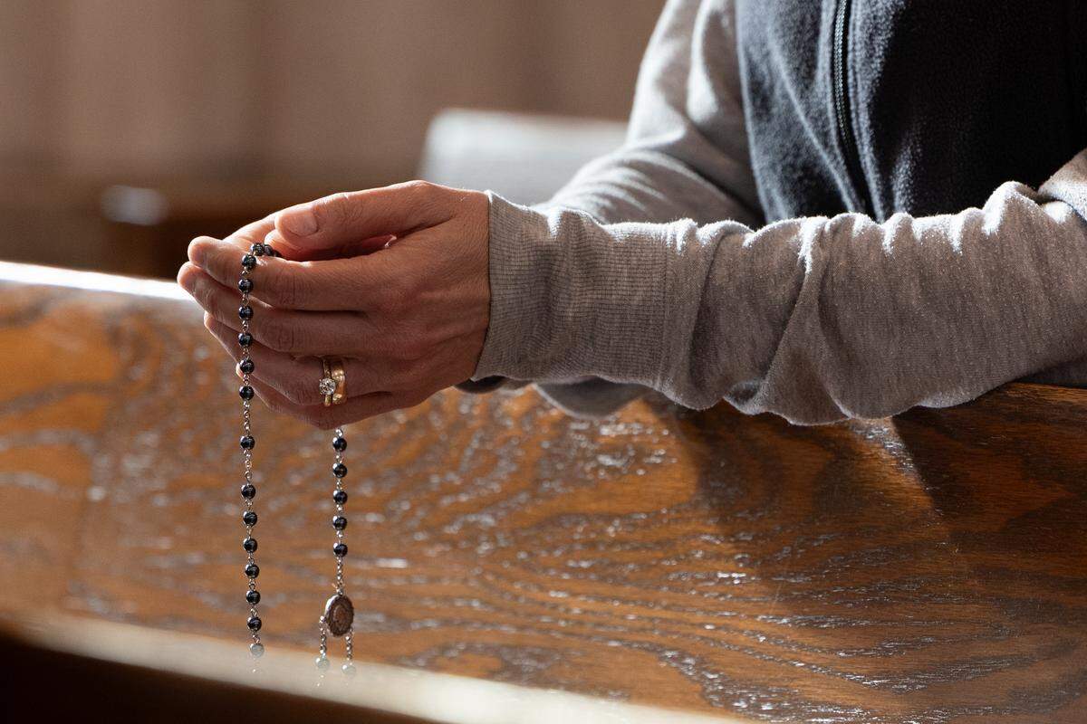 A mourner holds a rosary at Cathedral of St. Peter after the death of Pope Francis.
