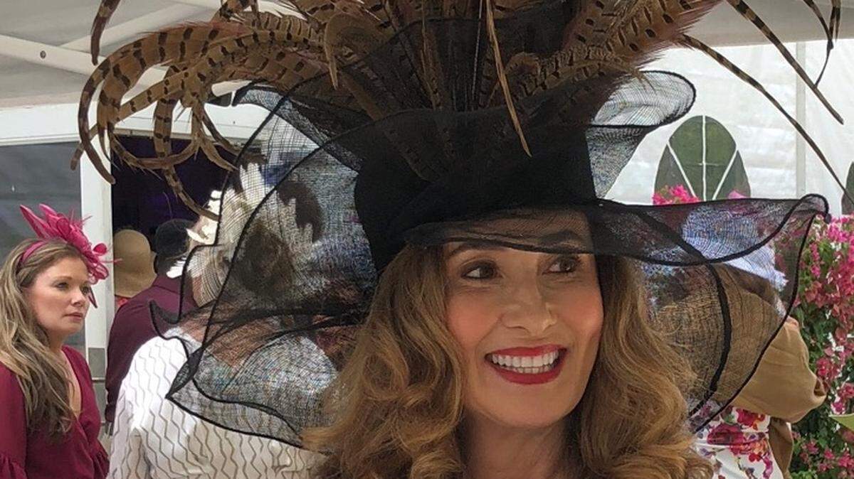 An unidentified woman wears a 2-foot-tall hat with a plume of pheasant feathers that was designed by Dianne Isbell. It recently was selected as “Best Hat” out of 500 hats at a fundraiser at Naples Botanical Garden in Florida.