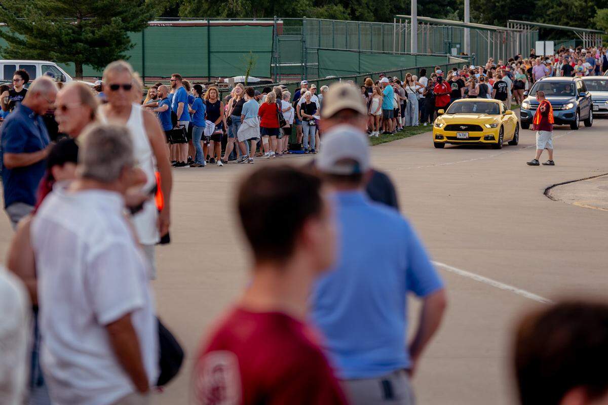 Thousands of people line prior to the beginning of a drum corps show at Belleville West High School on Tuesday, July 22, 2025, in Belleville.