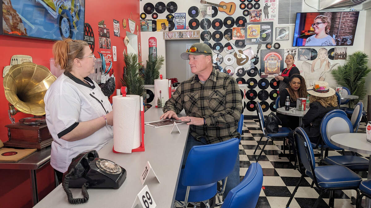 The Sugar Shack Café’s Head Pastry Chef, Natalia Everett, speaks with Rick Daily, Granite City Public Works Director, at the restaurant’s soft opening event.
