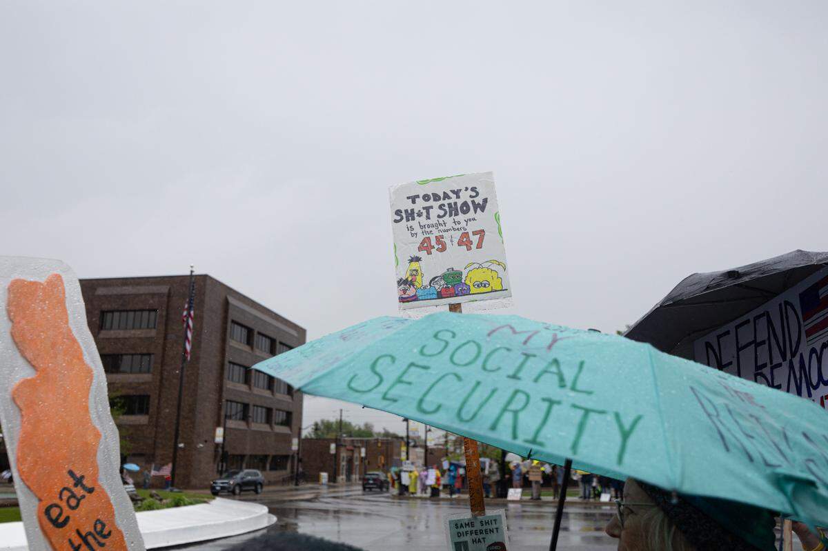 Various signs and umbrellas with slogans against the Trump administration on Belleville’s Public Square Saturday.