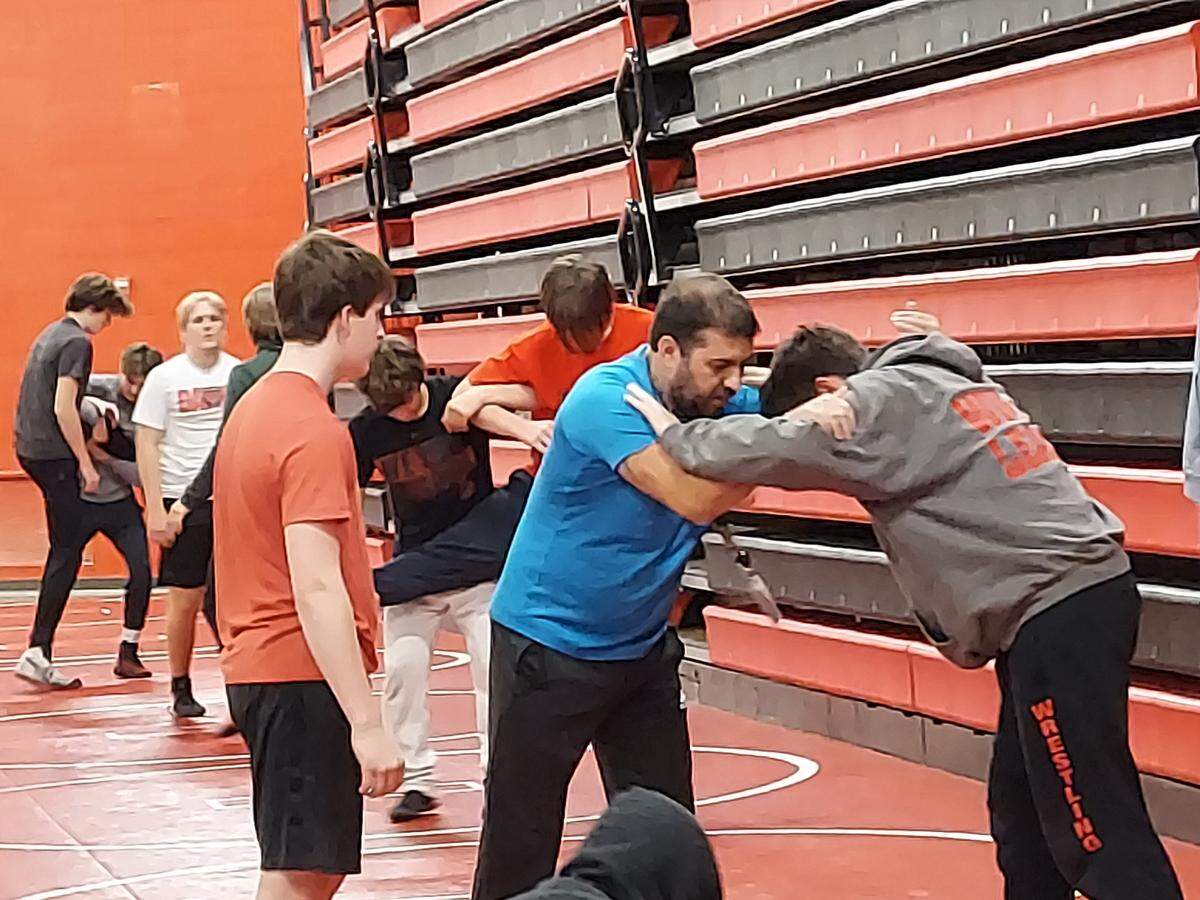 Highland assistant wrestling coach Nick Bellamy, center, shows a hold with assistant helper Benny Mitchell, right, as senior Will Jones watches during a recent practice at Highland High School. Youth will be the operative word that defines both the Highland High School boys and girls wrestling teams this winter.