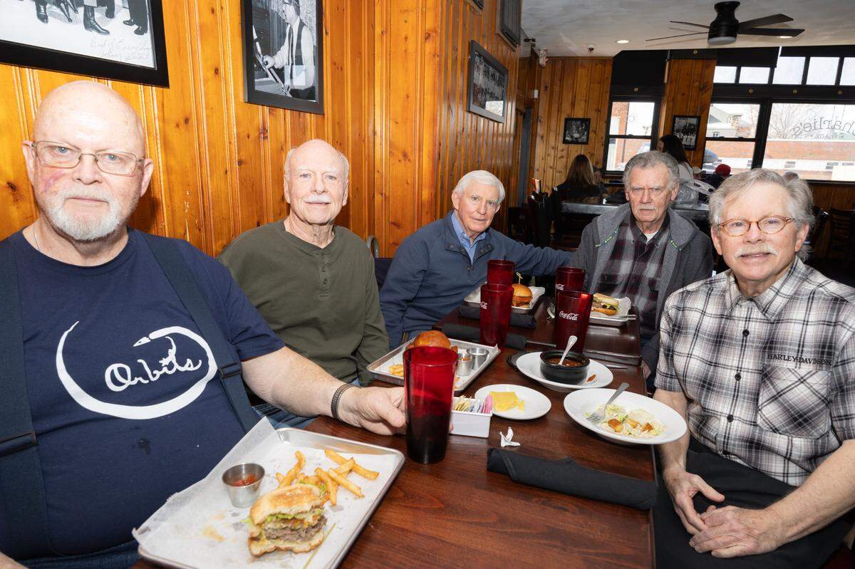 Members of The Orbits sit inside of Charlie’s in Belleville during one of the band’s reunions. “We’re all still great friends,” said John Goodwin, “we have very little disagreements.” Not pictured: guitarist Doug Phillips, who moved to South Dakota recently for work.