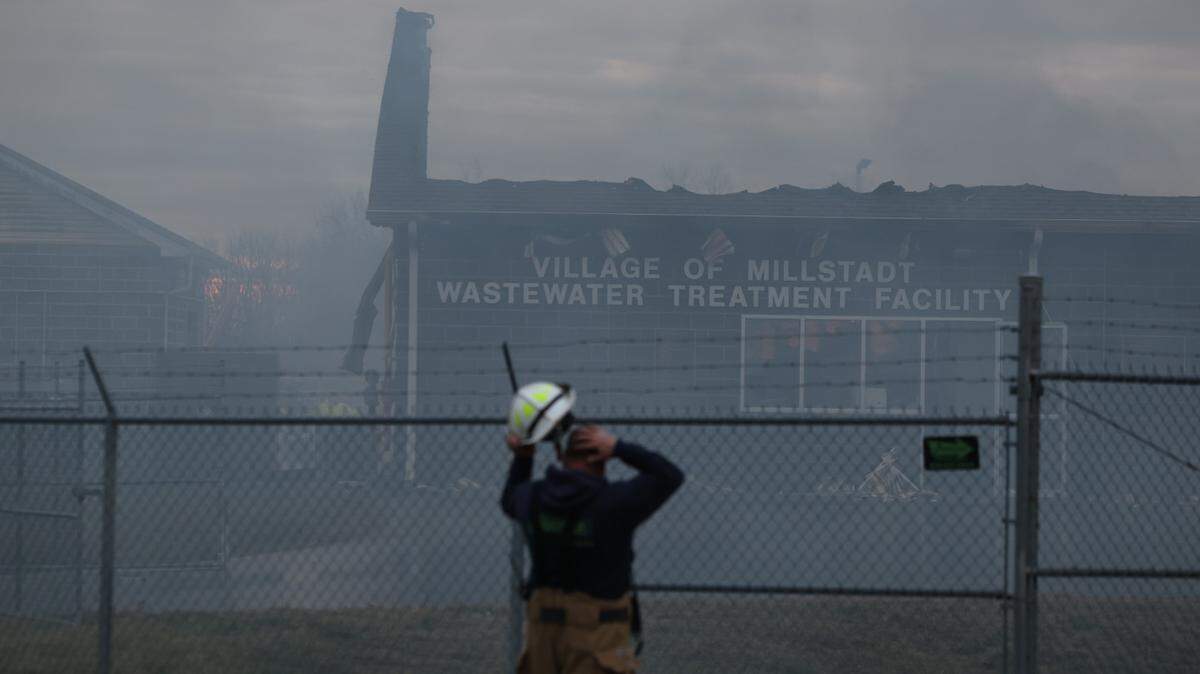 A first responder views the smoldering remnants of the Millstadt wastewater treatment facility Tuesday afternoon.