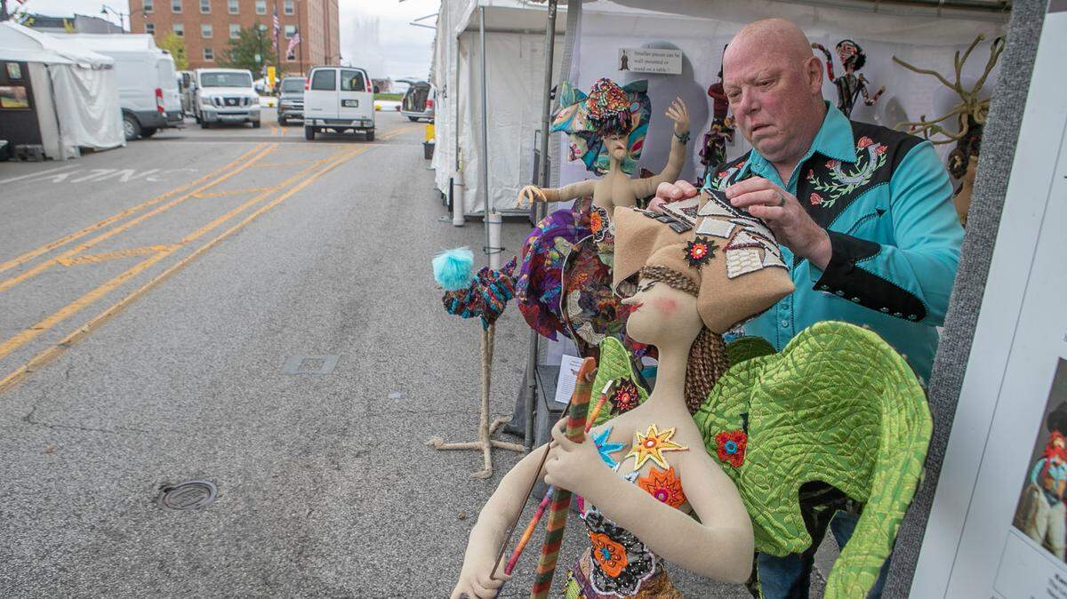 Sculpter Kent Epler puts the final touches on his art work as he prepares for the opening of Art On The Square in downtown Belleville. Epler and about 90 artists from around the country and one from Israel are scheduled to appear at Art on the Square in downtown Belleville Friday through Sunday.